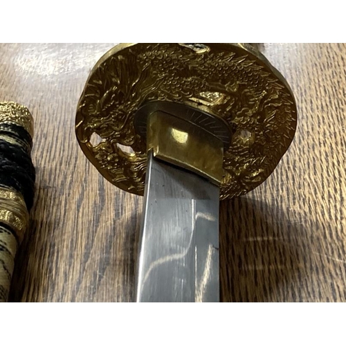 213 - Weapons: Replica Samurai sword 440 stainless steel blade in black and gilt lacquer case.