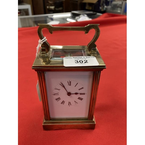 302 - Clocks & Watches: Early 20th cent. Brass carriage timepiece, Roman numerals on enamel face, French m... 