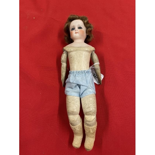 322 - 19th cent. Continental doll, porcelain head, kid leather jointed body, grey glass eyes, closed mouth... 