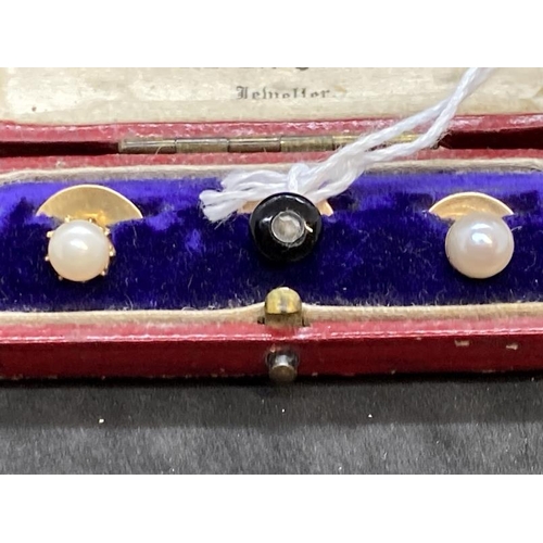 448 - Jewellery: Yellow metal set of three collar studs, two set with a pearl and one with onyx and a rose... 