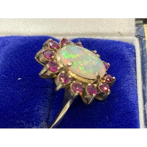 457 - Jewellery: Ring yellow metal oval cluster set with an oval cabouchon cut opal, estimated weight 3.25... 