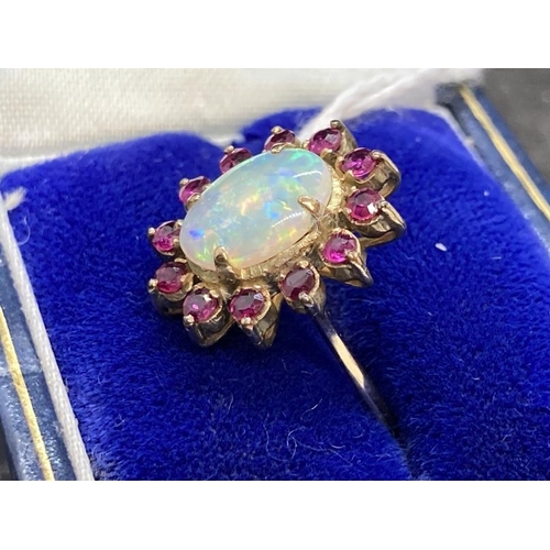 457 - Jewellery: Ring yellow metal oval cluster set with an oval cabouchon cut opal, estimated weight 3.25... 