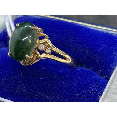 459 - Jewellery: Ring yellow metal set with an oval cabouchon cut jade, estimated weight 3.00ct, with a pa... 