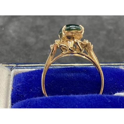 459 - Jewellery: Ring yellow metal set with an oval cabouchon cut jade, estimated weight 3.00ct, with a pa... 