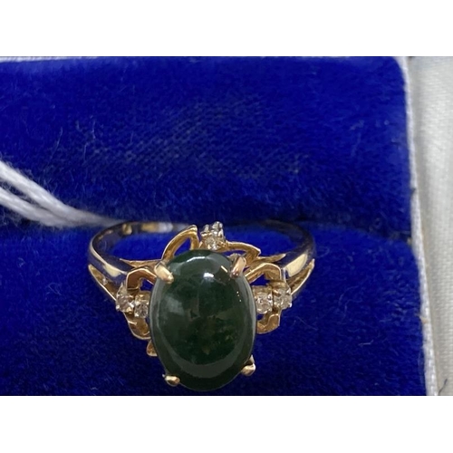 459 - Jewellery: Ring yellow metal set with an oval cabouchon cut jade, estimated weight 3.00ct, with a pa... 