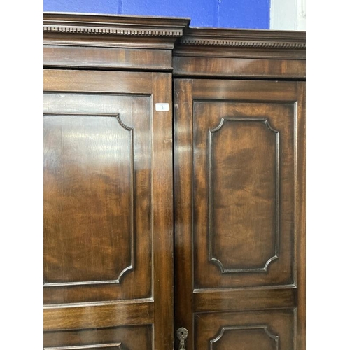 5 - 1920s mahogany break front wardrobe with castellated pelmet over four doors decorated with applied m... 