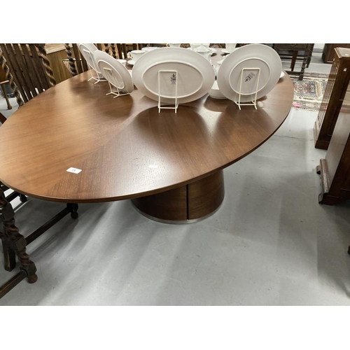 53 - Quatropi walnut dining table the oval top with inset circular central glass panel supported by a cen... 
