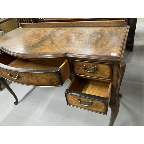 64 - 1920s bow front writing desk on cabriole supports with acanthus decoration to the knee. 44ins. x 19½... 