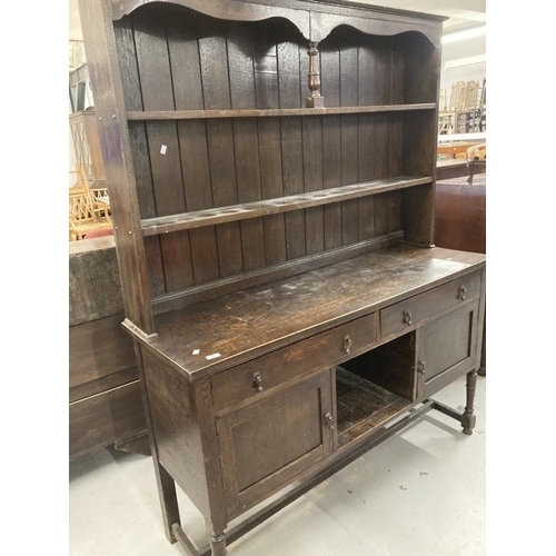 74 - Early 20th cent. Stained oak dresser with two shelves, two drawers and two cupboards on turned suppo... 