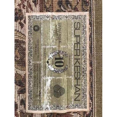9 - Rugs: Super Keshan green ground rug. Approx. 118ins. x 173ins.