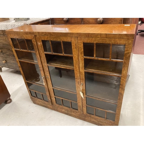 90 - Art Deco: 1930s walnut dwarf three door display cabinet of elegant form. 12ins. x 48ins. x 42ins.