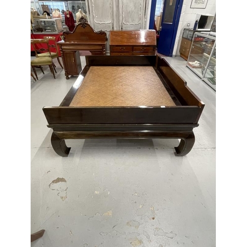 101 - Chinese large hardwood bed with rattan covered base (Repair to one leg) . 81ins. x 59ins.