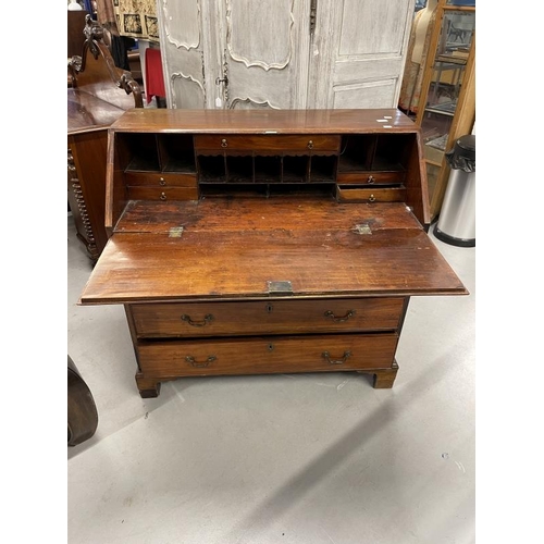 103 - Late 18th cent. Mahogany bureau the hinged fall revealing a fitted interior of drawers and pigeon ho... 