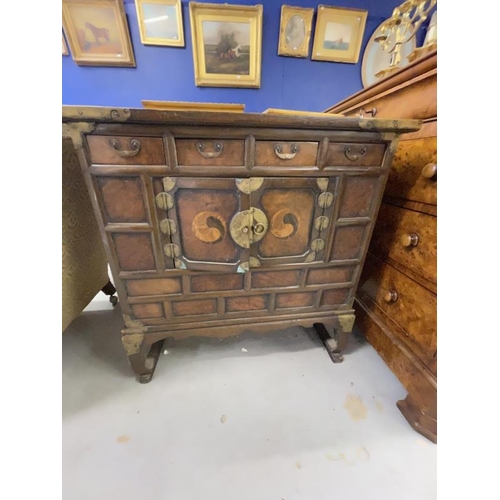 117 - 19th cent. Asian, marriage chest decorated with inset yin and yang, with brass mounts. 33ins. x 16in... 