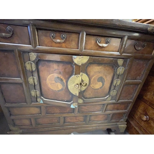 117 - 19th cent. Asian, marriage chest decorated with inset yin and yang, with brass mounts. 33ins. x 16in... 