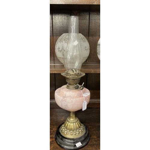 13 - Victorian oil lamp black ceramic base, brass base pink glass reservoir, round etched shade. 23ins.