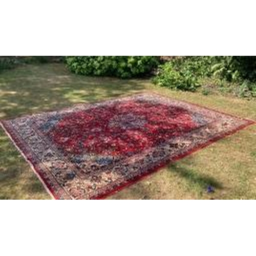 19 - Carpets: A good red ground Wilton Persian rug, cost when new approx. £1500. 111ins. x 151½ins.