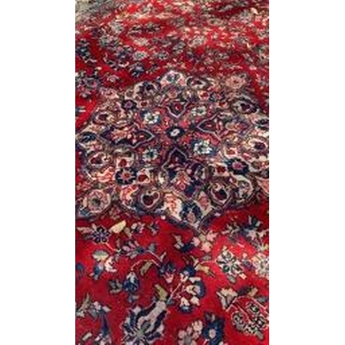 19 - Carpets: A good red ground Wilton Persian rug, cost when new approx. £1500. 111ins. x 151½ins.