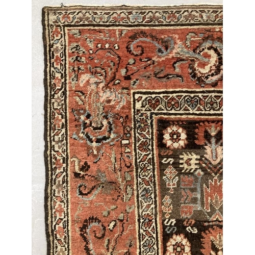 26 - Rugs & carpets: Late 19th cent. Persian rug, black ground central panel decorated with stylised flow... 