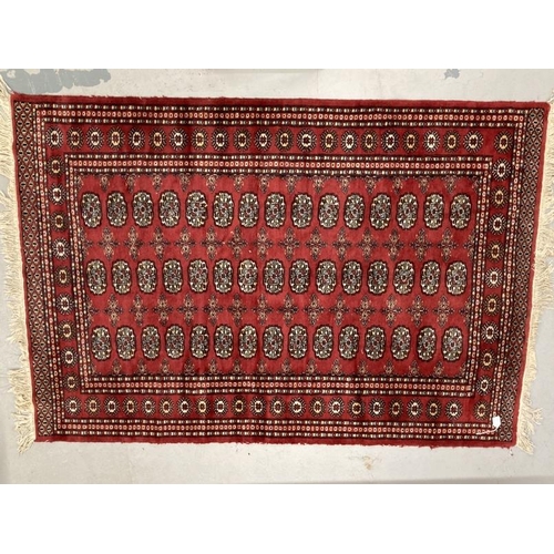 27 - Carpets & Rugs: Late 19th/early 20th cent. Turkman rug, red ground with a central panel containing f... 