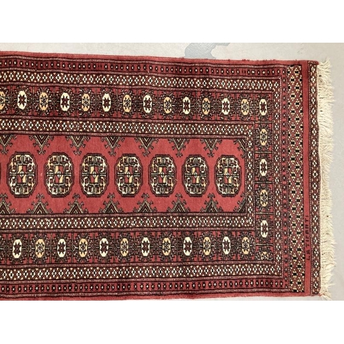 29 - Carpets & rugs: 20th cent. North African runner in the style of a Turkman, red ground central panel ... 