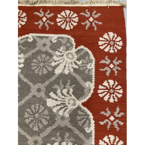 32 - Carpets & Rugs: Oriental carpet, grey ground with red border, stylised floral decoration, all in gre... 