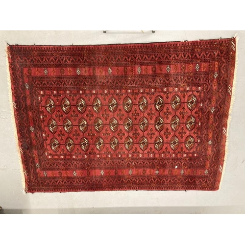 33 - Carpets & rugs: 19th cent. Turkman rug, red ground with a central panel containing forty guls, with ... 