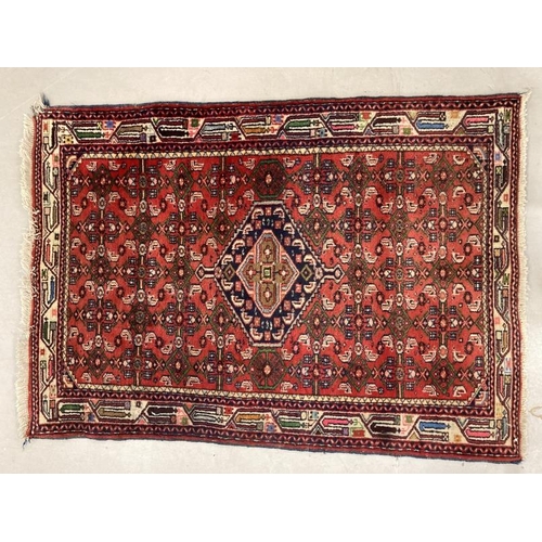 35 - Rugs: Turkish style rug in reds and blues. 56ins. x 40ins.