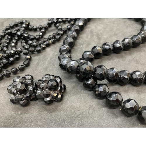 566 - 19th cent. Black glass jewellery, necklaces one with matching earrings. 18ins. and 40ins.