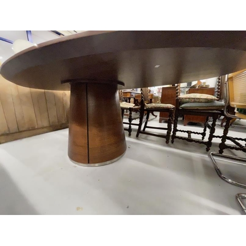 71 - Quatropi walnut dining table the oval top with inset circular central glass panel supported by a cen... 