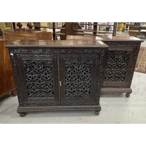 103 - 19th cent. Anglo Indian teak cabinets c1860 with carved and pierced cupboard doors and sides enclosi... 