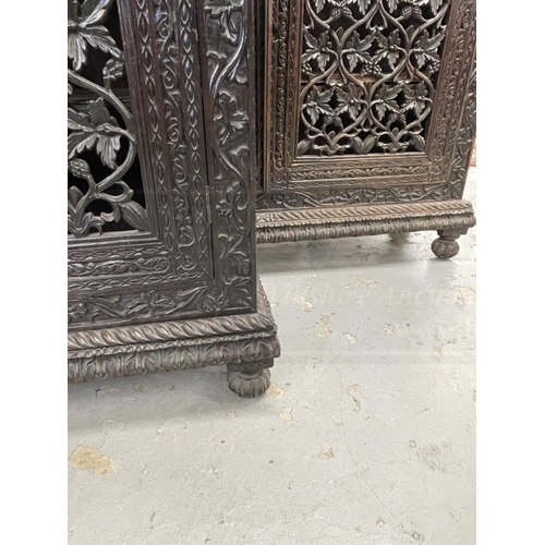 103 - 19th cent. Anglo Indian teak cabinets c1860 with carved and pierced cupboard doors and sides enclosi... 