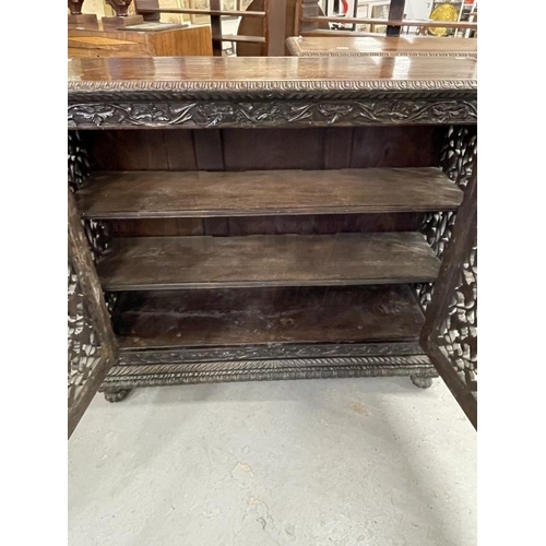 103 - 19th cent. Anglo Indian teak cabinets c1860 with carved and pierced cupboard doors and sides enclosi... 