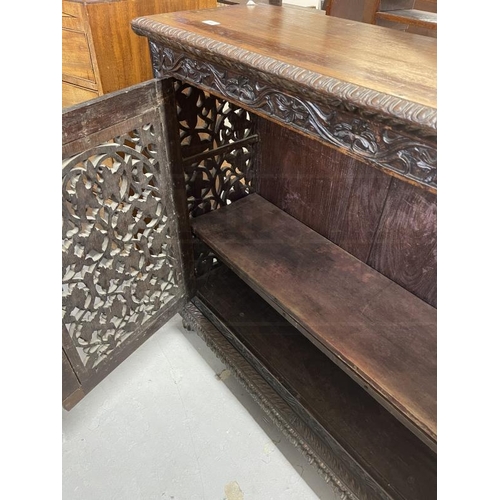 103 - 19th cent. Anglo Indian teak cabinets c1860 with carved and pierced cupboard doors and sides enclosi... 