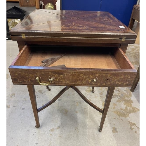 117A - Sheraton Revival mahogany inlaid bridge/envelope table on tapering supports.