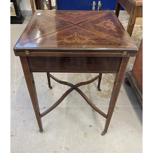 117A - Sheraton Revival mahogany inlaid bridge/envelope table on tapering supports.