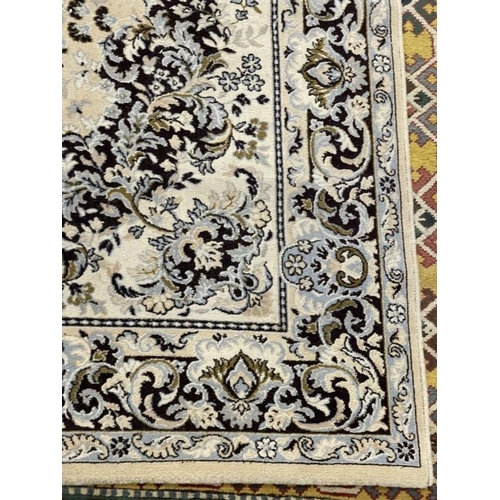 137 - Carpets & Rugs: 20th cent. English carpet, ivory ground with floral decoration in blues, browns, whi... 