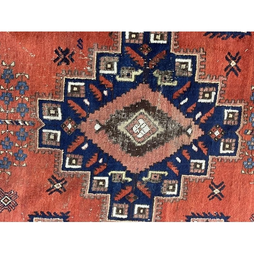 140 - Carpets & Rugs: 19th cent. Persian carpet, red ground, five medallions with geometric designs, four ... 