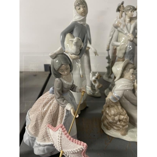 197 - Porcelain: 20th cent. Lladro figures girl with a lamb 11ins, boy with goat 11ins, boy seated with bi... 