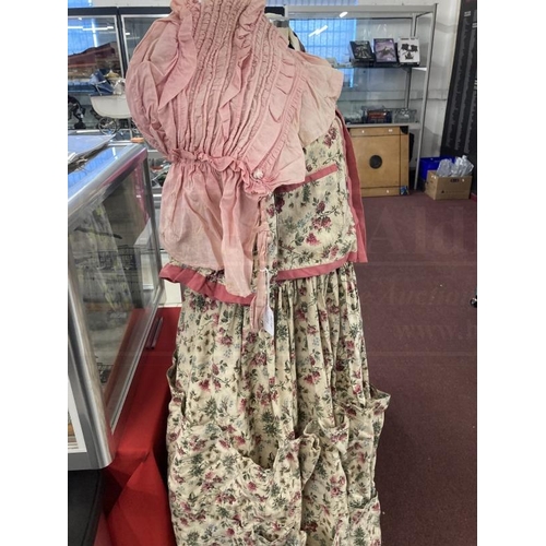 312 - Fashion: Period cotton dress printed with sprays of pink flowers, the full skirt is decorated with n... 