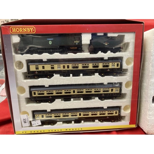 338 - Toys: Hornby OO trains one boxed set, one cased set with tracks and various carriages, etc.