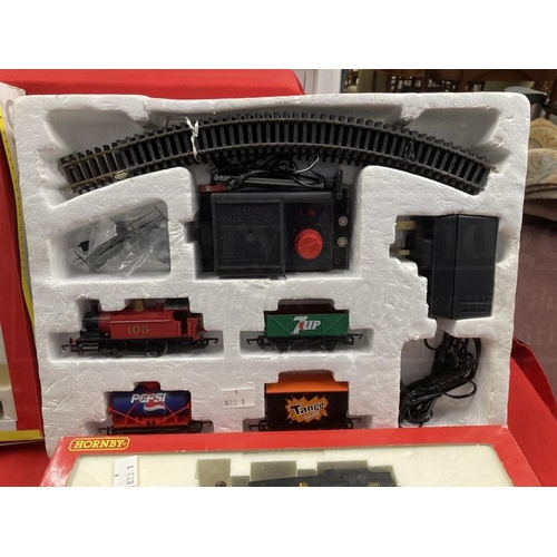 338 - Toys: Hornby OO trains one boxed set, one cased set with tracks and various carriages, etc.