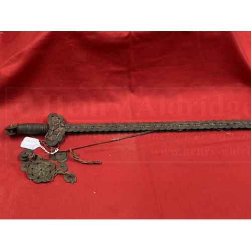 395 - Weapons: Chinese coin sword, iron roil with Chinese coins of the 19th cent. tied to it with red and ... 