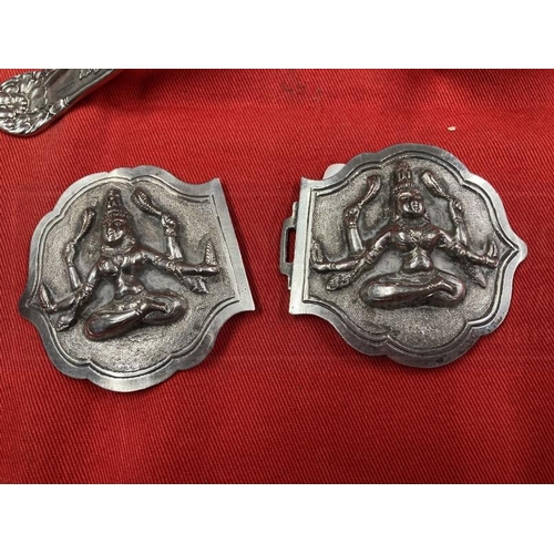 402 - Collectables: Southern Asian white metal belt buckles depicting Kali, a quartz carving of Buddha in ... 