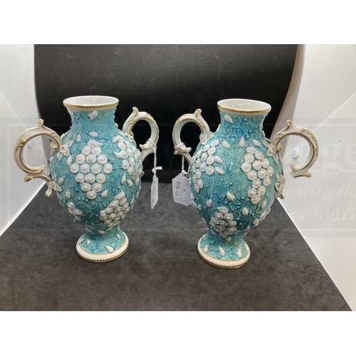 437 - Chelsea Derby two handled vases c1770 applied with clusters of small white flowers on a turquoise gr... 