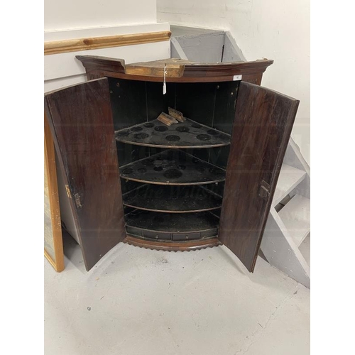 47 - Late 18th cent. Mahogany bow front corner cupboard, moulded cornice above two doors flanked by flute... 