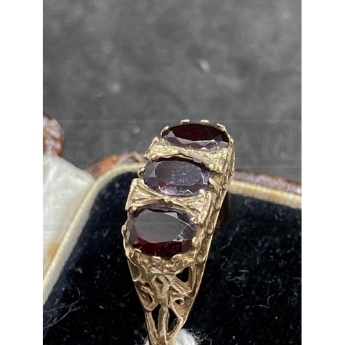 502 - Hallmarked Jewellery: 9ct gold ring set with three oval cut garnets, estimated weight of (3) 3.00ct,... 