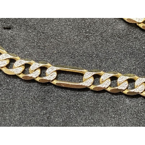 511 - Hallmarked Jewellery: 9ct yellow and white gold fancy curb link necklet. 22ins. Weight 15.4g.