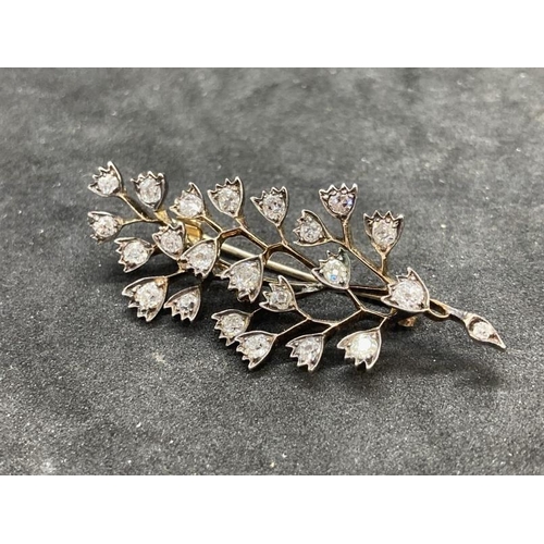 517 - Jewellery: Yellow metal brooch in the form of a spray set with twenty-three old cut diamonds, estima... 