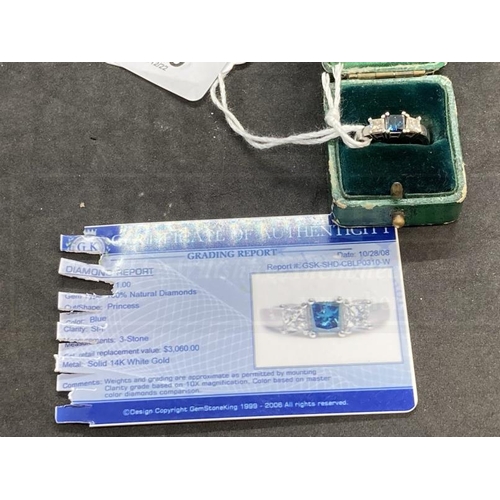 519 - Jewellery: White metal ring set with three princess cut diamonds, centre diamond blue in colour, est... 